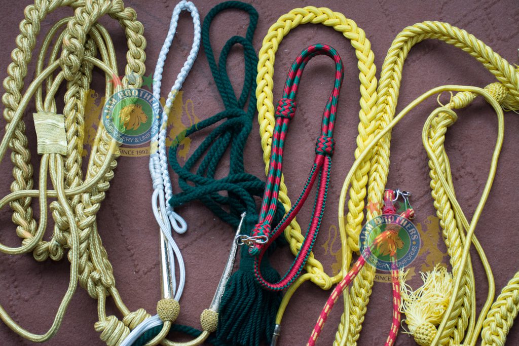 Lanyard Sword Knot Aiguillettes Braid Rope Ribbon Accessories Military Uniform Accouterments Lace Trimming Braid Gold White Silver Blue Weave Weaving Uniforms Accouterments Tailor Belts Leather Ceremonial Combat Cadet Parade Belts #Hand Embroidery #BullionEmbroidery #TradeBadges #MessDress #Badges #Ranks #Regiment #Parade #Ceremonial #Cord #Textile #ArmedForces #BritishArmy #Army #Aiguillette #Military #MilitaryUniforms #Militaria #Insignia #Headwear #Caps #OfficerCaps #UniformCaps #PeakCaps #DressCaps #MilitaryCaps #RailCap #Berets #Glengarry #RoyalNavy #RoyalMarine #RoyalAirForce #RAF #Infantry #Armor #EME #Battalion #Medals #Ribbons #Braid #Lace #Uniforms #UniformSupplie #Police #Security #Buckles #Guards #Accoutrement #Badge #Patch #Machine #MachineEmbroidery #HandEmbroidery #Bullion #BullionBadges #BullionEmbroidery #WovenBadges #Woven # Emblems #Regiment #Regimental #OfficerCaps #PeakCaps #Soldier #Helmets #Covers #HelmetCovers #Armlets #Sliders #Epaulettes #Webbing #Chevron #Officer #ShoulderBoards #Gorgets #Tassel #Sash #Hand #HandSewn #Aviation #AviationClothing #Crest #FamilyCrest #CoatofArms #EmbroideredPillows #Cords #Aiguillettes #CapCords #ChinCord #DressCord #SwordKnot #Tassels #WhistleCord #Lanyard #Knots #Banners #ClanBadges #Peaks #Visor #Wings #CapBadges #Pennants #HonorCaps #OfficerCaps #SportsCap #Masonic #Aprons #MasonicAprons #Collars #MasonicCollars #Gloves #MasonicGloves #MasonicPatches #Patches #Regalia #MasonicRegalia #Freemason #Braid #Chevron #Cuffs #Fringes #Sashes #HeadGear #FieldGear #England #USA #Poland #ArmedForces #Schools #Colleges #University #Sialkot #Pakistan Sialkot Pakistan PeakCaps OfficerCaps ShoulderRanks BullionBadges UniformAccessories MilitaryUniforms DressCap TradeBadge RankMarking WireBadges Army Airforce Navy Police